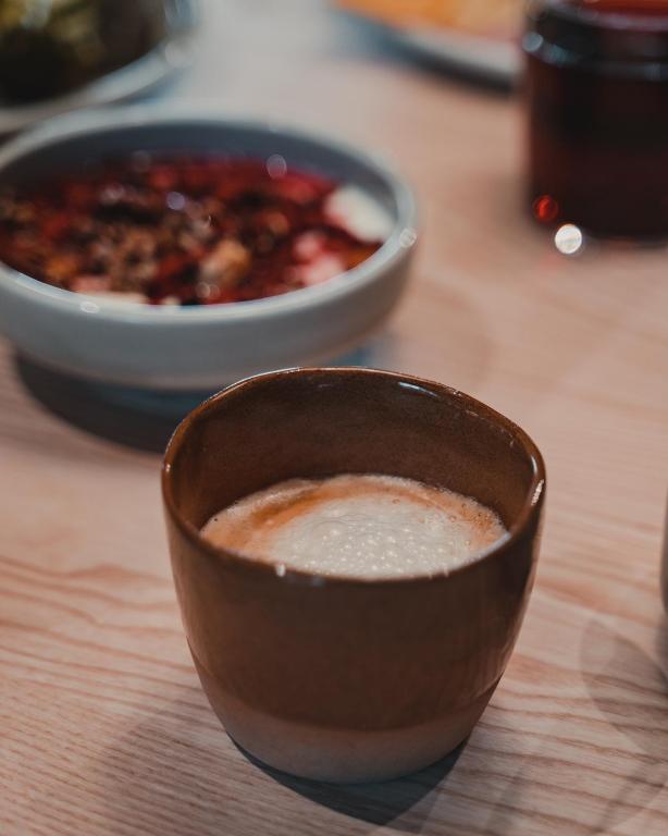 a bowl of chili and a bowl of soup on a table at VALO Hotel & Work Helsinki in Helsinki
