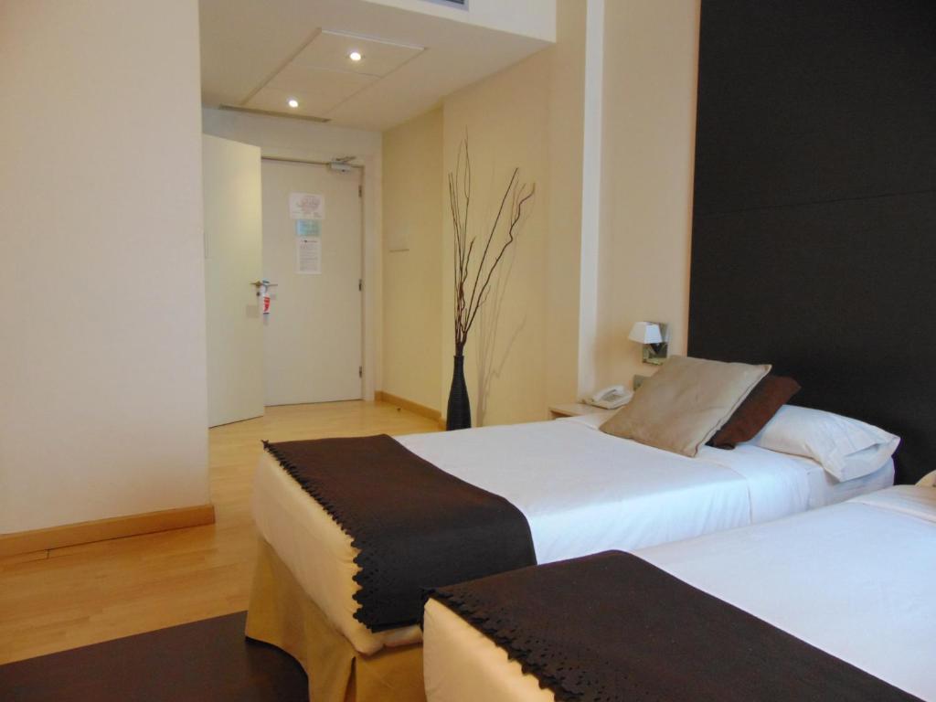 Postel nebo postele na pokoji v ubytování Hotel Ortuella