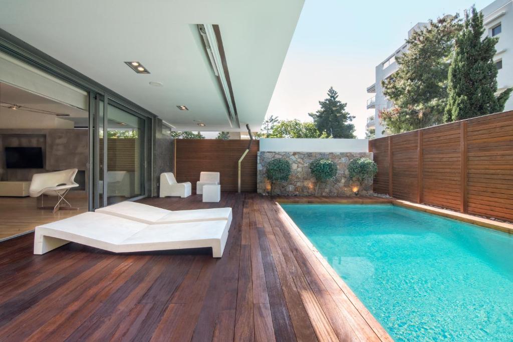 a bedroom with a pool and a bed and a swimming pool at Elegant and Private Living by Neuvel in Athens
