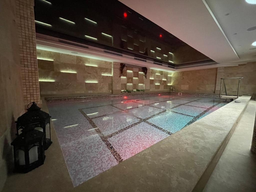 an empty swimming pool in a large building at Hotel Alexandar Lux in Podgorica