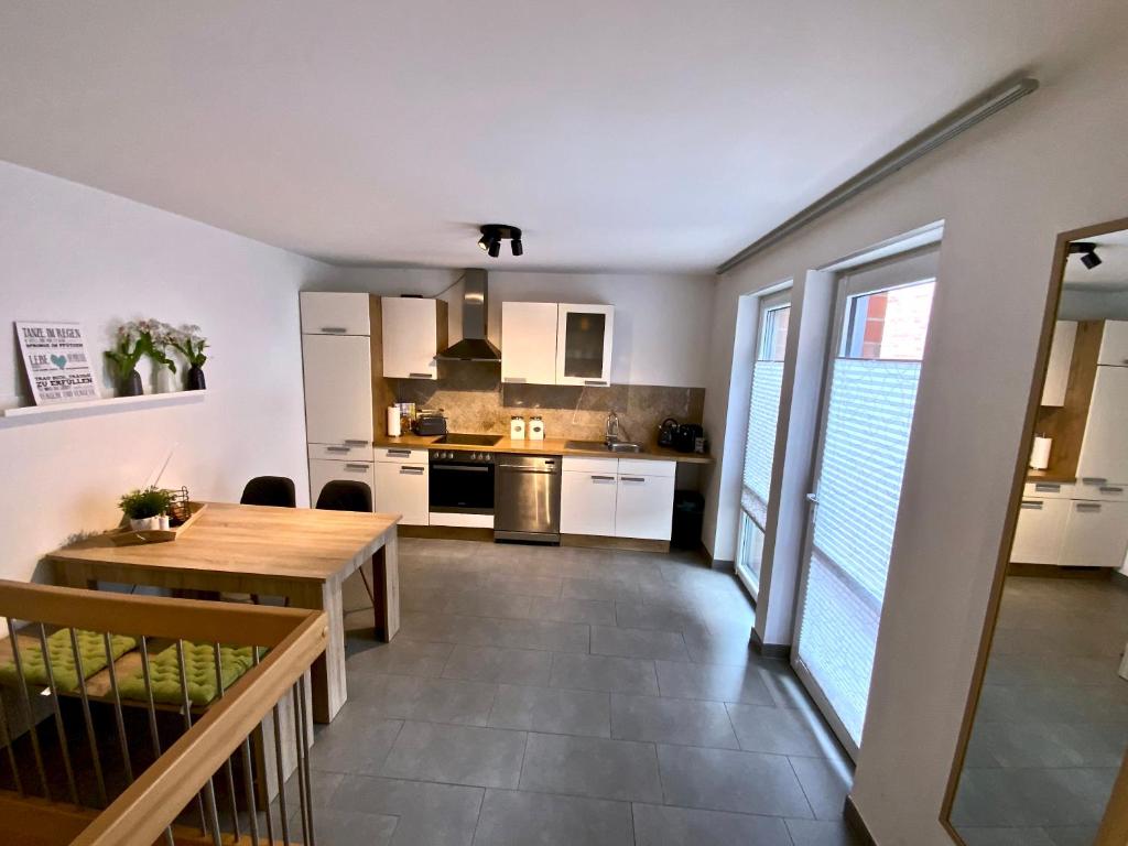 a kitchen and dining room with a wooden table at 4*+ Maisonette-Apartment in Brüggen