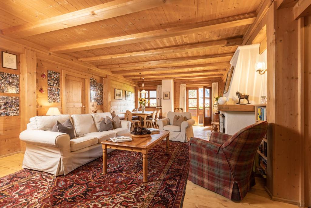 a living room with a couch and a table at Chalet Innerhof in Alpbach