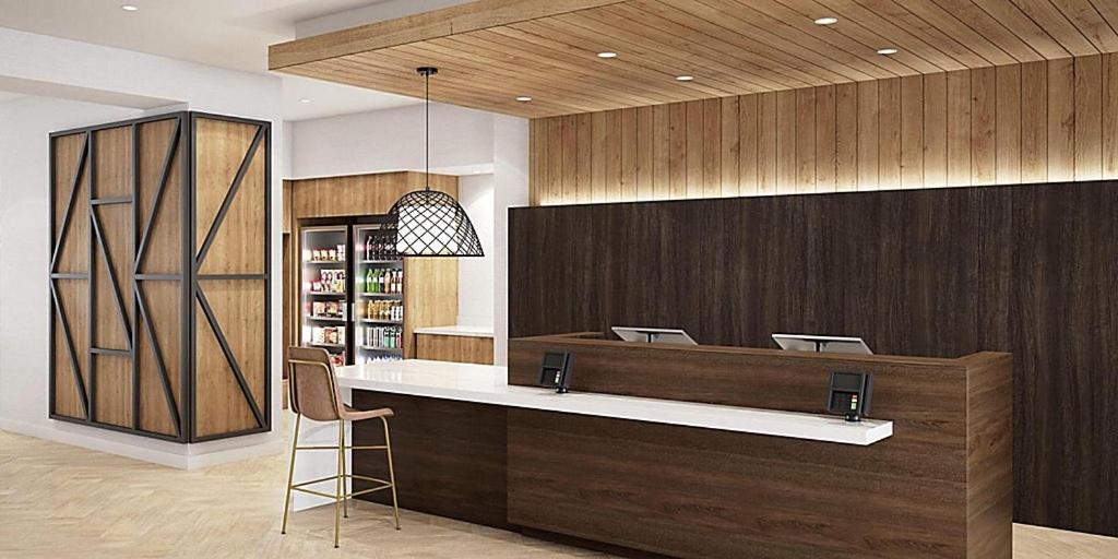 a lobby with a bar with a chair in it at Staybridge Suites - Portland, an IHG Hotel in Portland