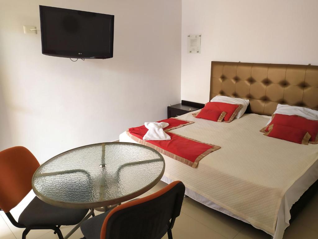 Postel nebo postele na pokoji v ubytování Hotel Plaza Colonial