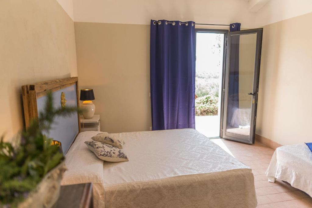 Postel nebo postele na pokoji v ubytování Agriturismo SS Annunziata