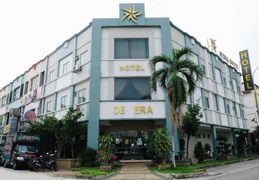 a large white building with a star on it at De Era Hotel in Seri Kembangan