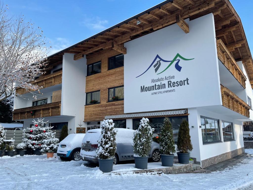 a sign for the mountain resort in the snow at Absolute Active Mountain Resort in Kirchberg in Tirol