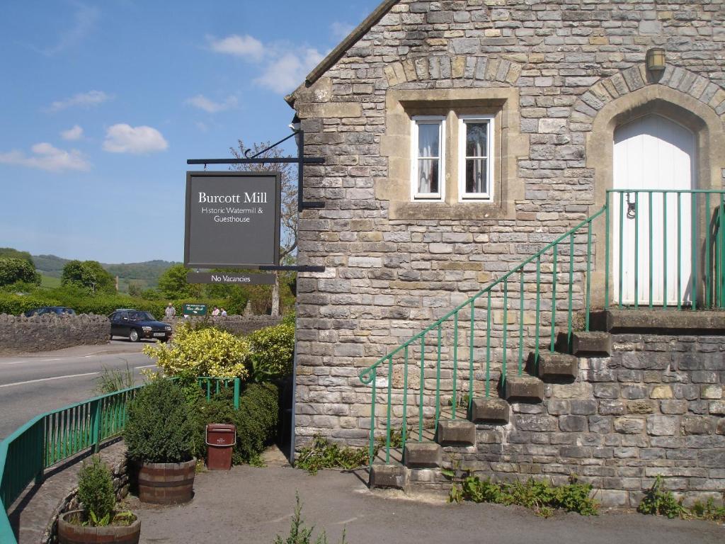 a stone building with a sign on the side of it at Mill Lodge in Wells