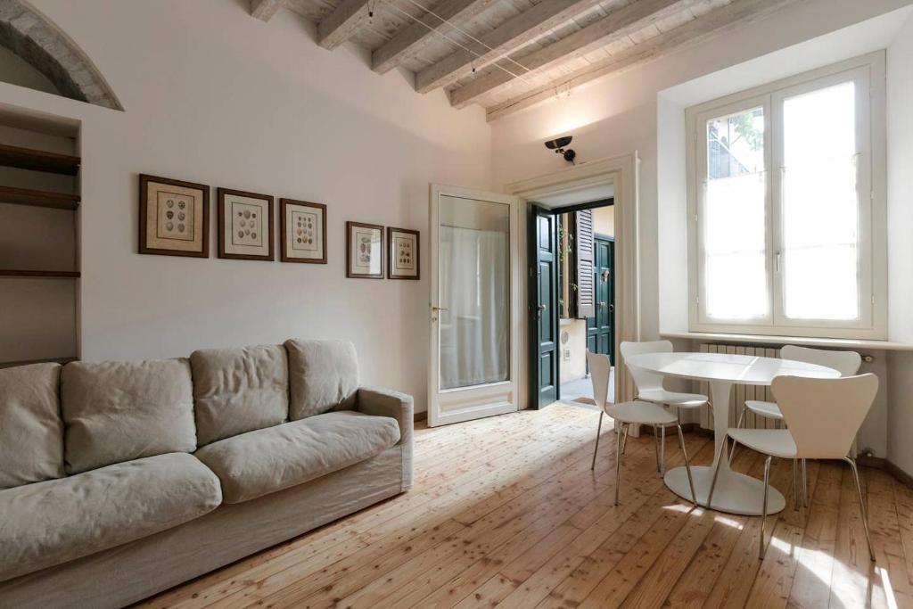 a living room with a couch and a table at Naviglio, sweet dreams in the heart of the fun in Milan
