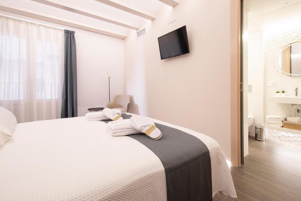 Postel nebo postele na pokoji v ubytování Hotel 1877 Sensaciones & SPA ADULTS ONLY