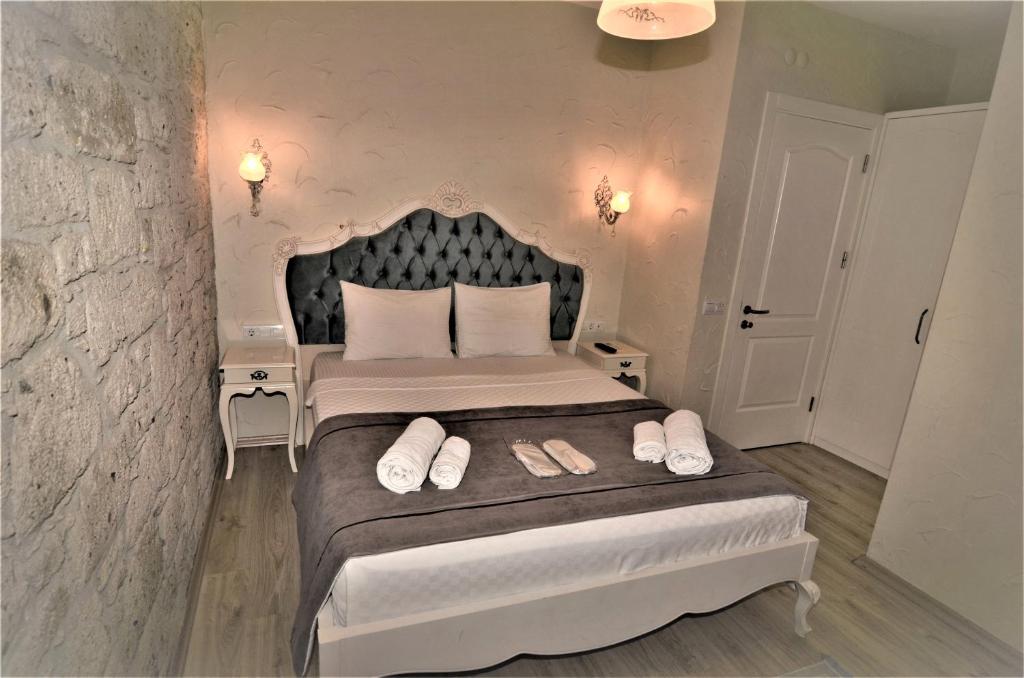 A bed or beds in a room at Alacati Eldoris Butik Hotel