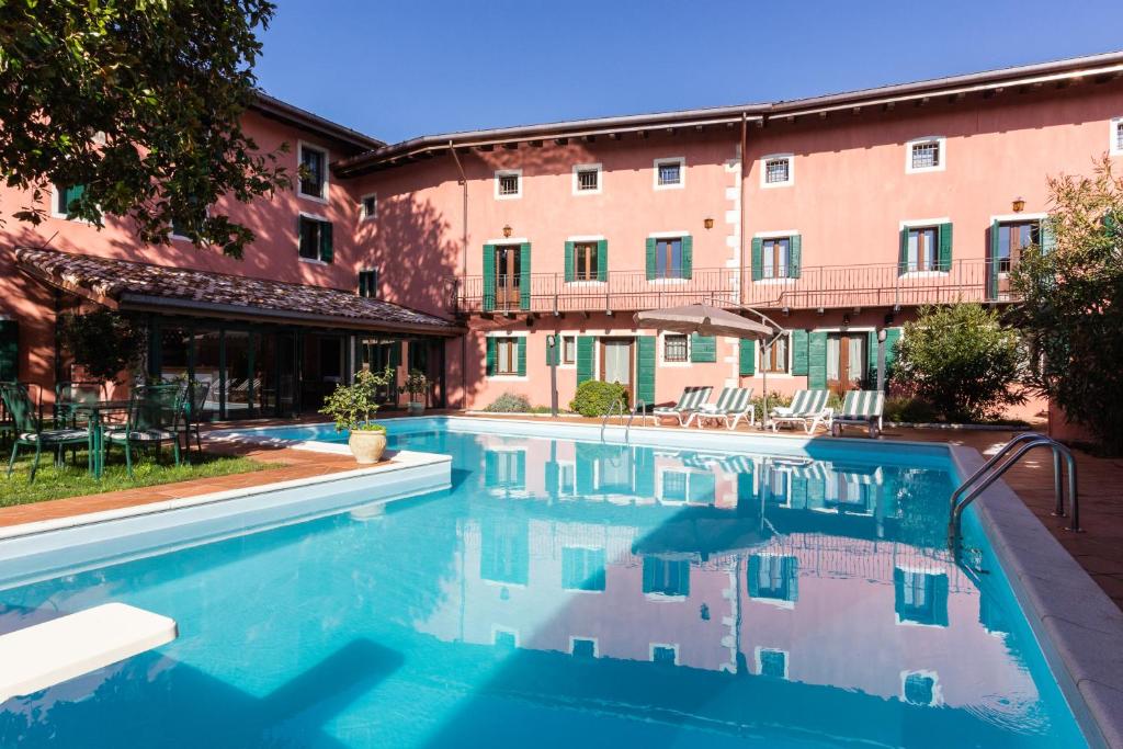 a swimming pool in front of a building at Ciasa De Gahja in Budòio