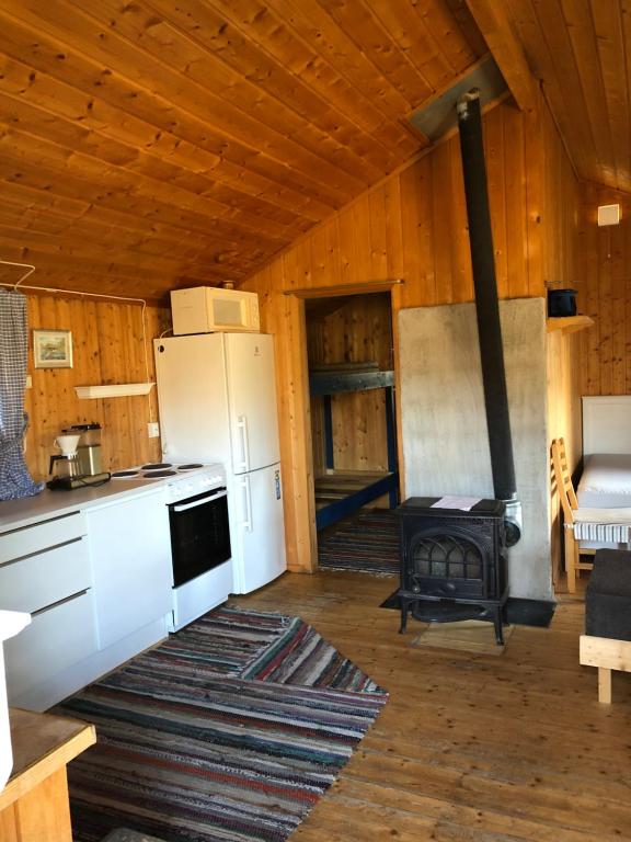 a kitchen with a white refrigerator and a stove at Nye hytta,Holmfoss/Kvelde in Larvik