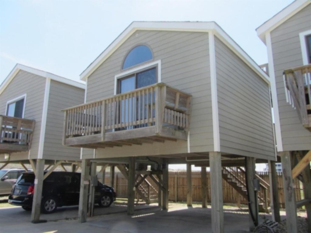 a house with two decks and a car at NC 12 56821-11 Condo in Hatteras