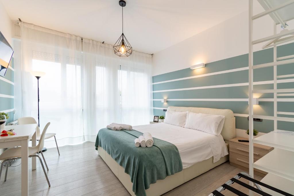 a bedroom with a bed with a blue and white striped wall at 4 Star Bologna Train Station - Self Check-In in Bologna