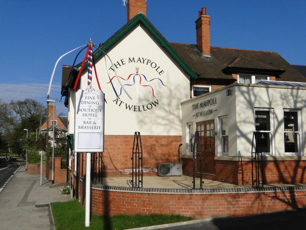 a white building with a sign in front of it at The Maypole at Wellow in Ollerton