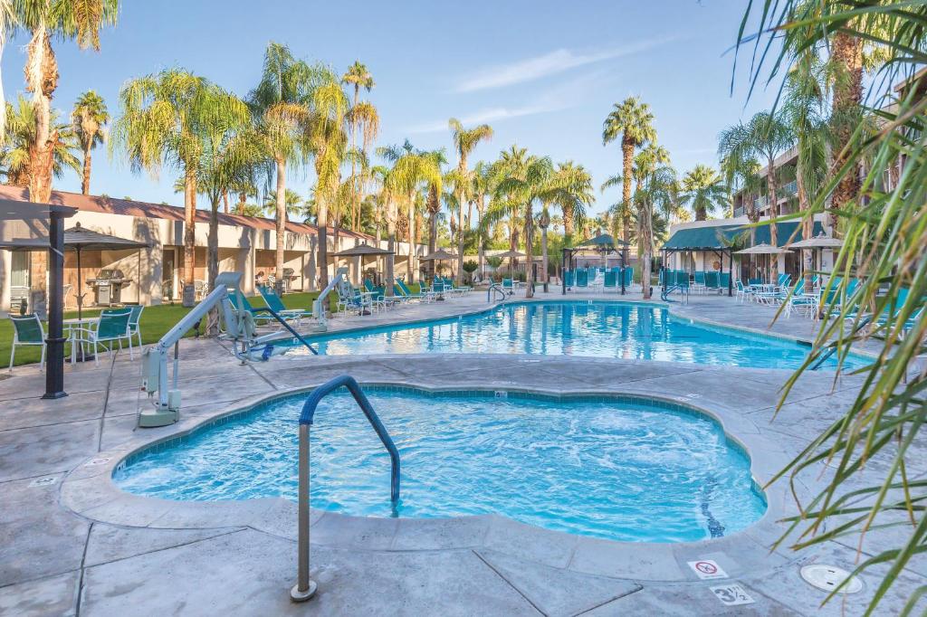 - une piscine dans un complexe avec des palmiers dans l'établissement WorldMark Palm Springs, à Palm Springs