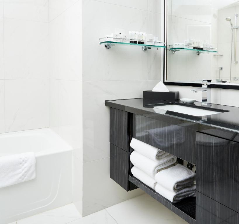 a bathroom with a sink and a mirror at Granville Island Hotel in Vancouver