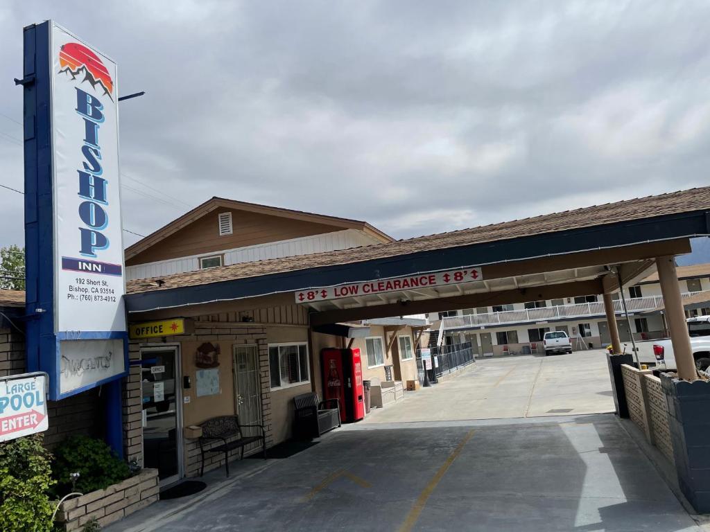 an empty gas station with a sign in front of it at Bishop Inn in Bishop