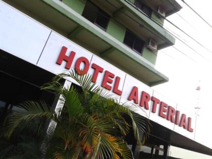 a hotel sign on the side of a building at Hotel Arterial in Foz do Iguaçu