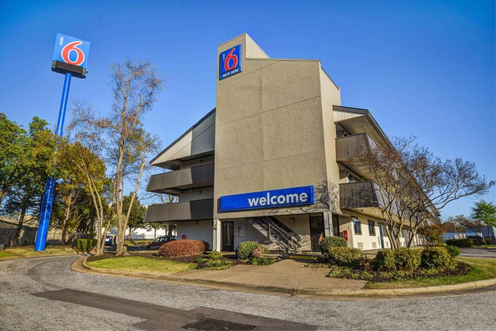 un edificio con una señal de bienvenida delante de él en Motel 6-Memphis, TN - Downtown en Memphis