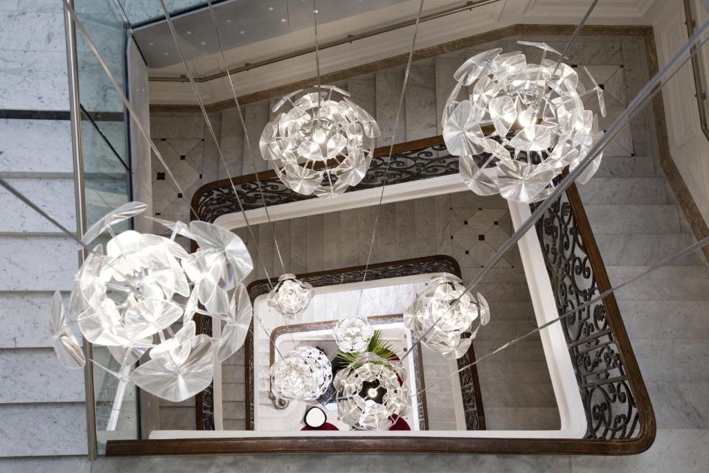 a group of chandeliers hanging in a room at Hotel C2 in Marseille