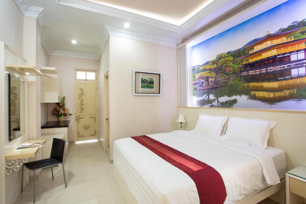 Кровать или кровати в номере Griya QQ Guest House