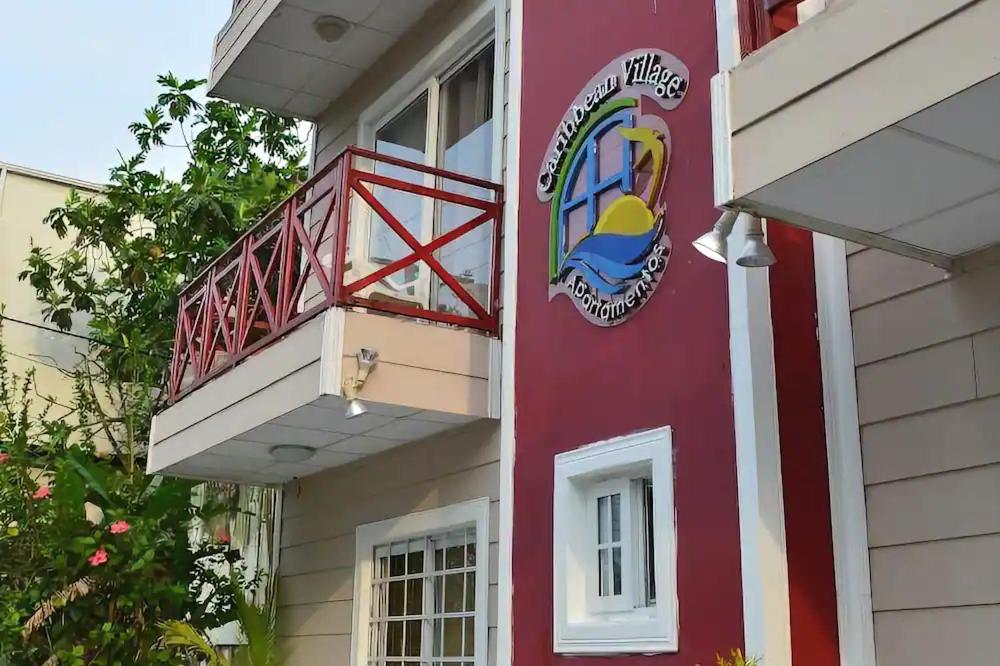 a building with a sign on the side of it at Caribbean Villages Aparments in Bocas Town