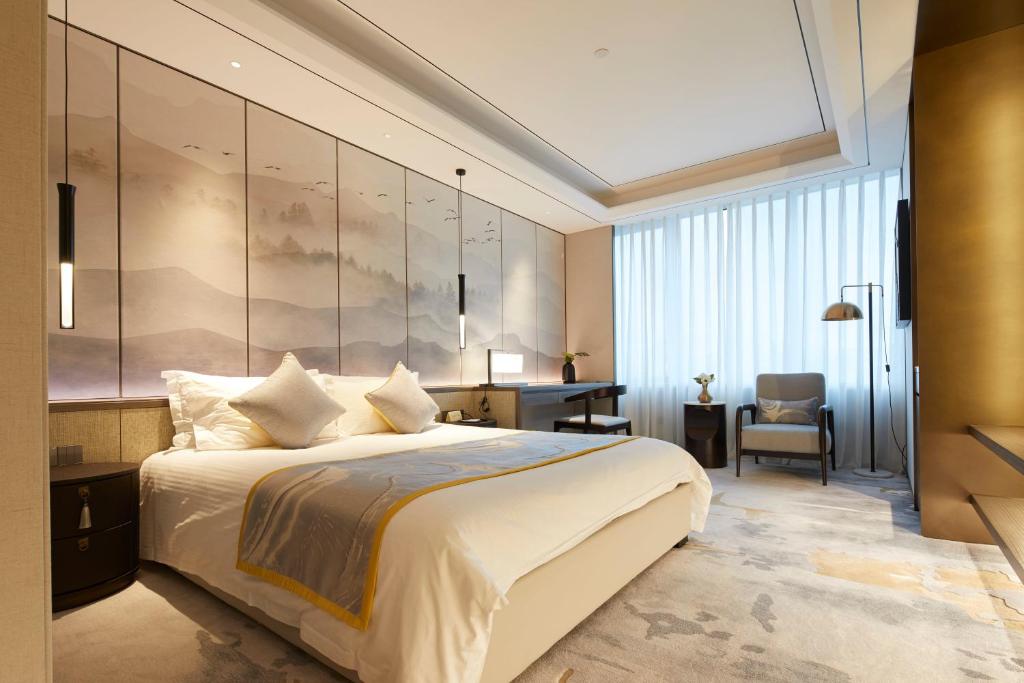 Postel nebo postele na pokoji v ubytování Shanghai Tiancheng Hotel