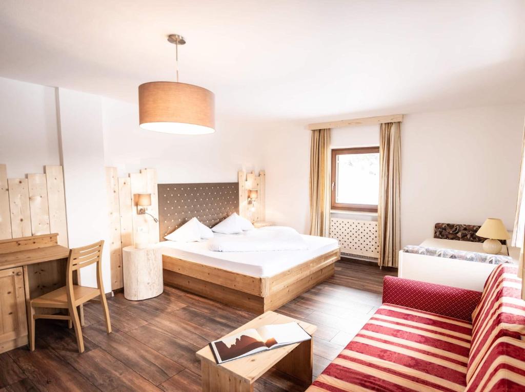 Postel nebo postele na pokoji v ubytování Hotel Profanter