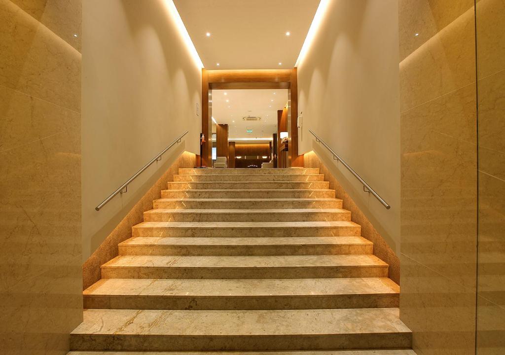 a staircase in a building with a stair case at Hotel Crystal Plaza in Ernakulam