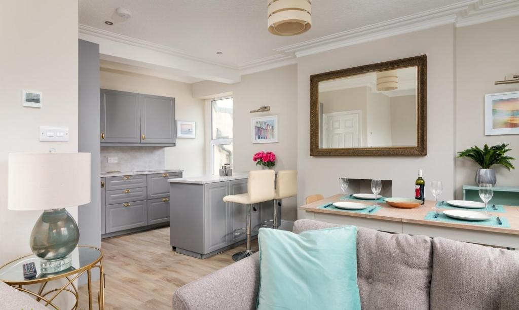 ein Wohnzimmer mit einem Sofa und einem Tisch mit einem Spiegel in der Unterkunft Gorgeous cottage by sandy beach Dog friendly in Port Erin