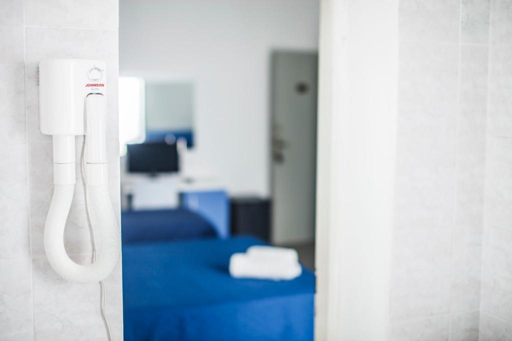 Postel nebo postele na pokoji v ubytování Hotel Rex