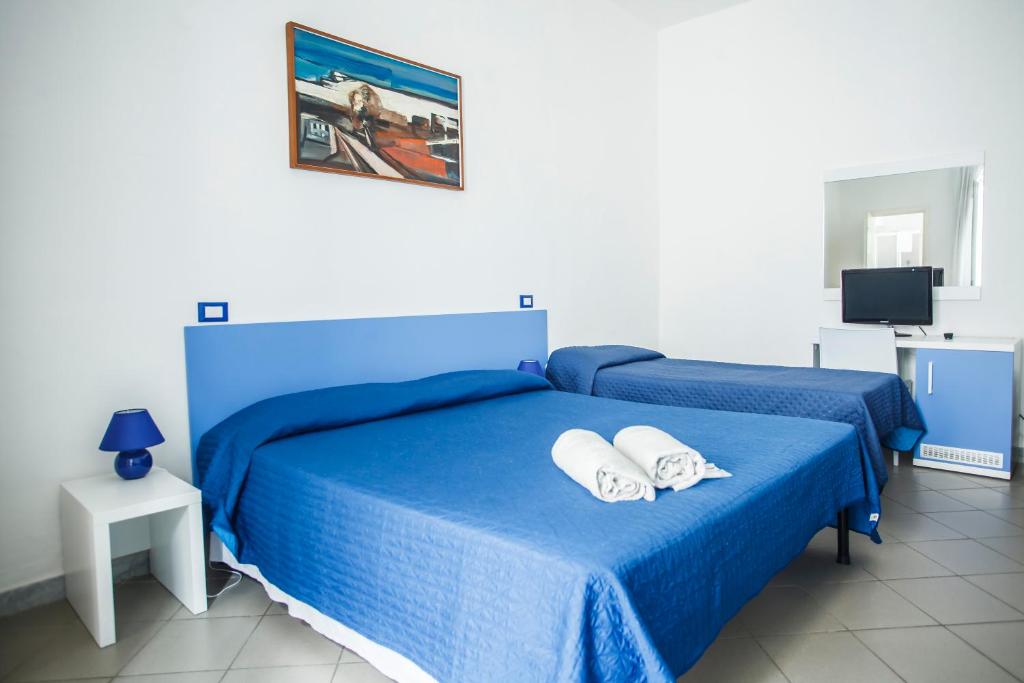 Postel nebo postele na pokoji v ubytování Hotel Rex