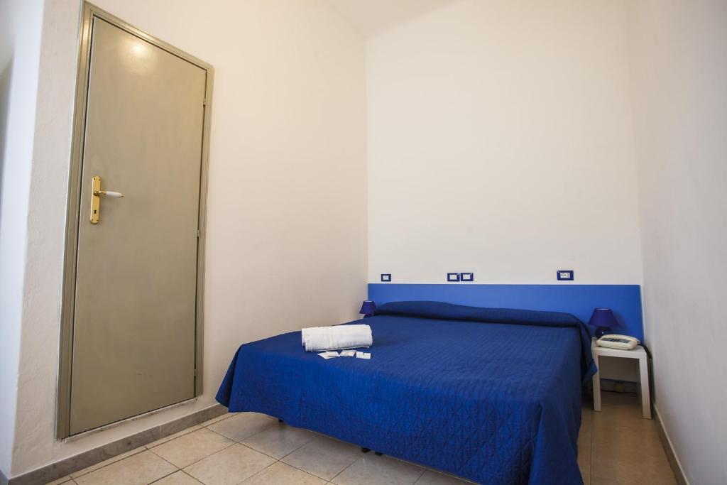Postel nebo postele na pokoji v ubytování Hotel Rex