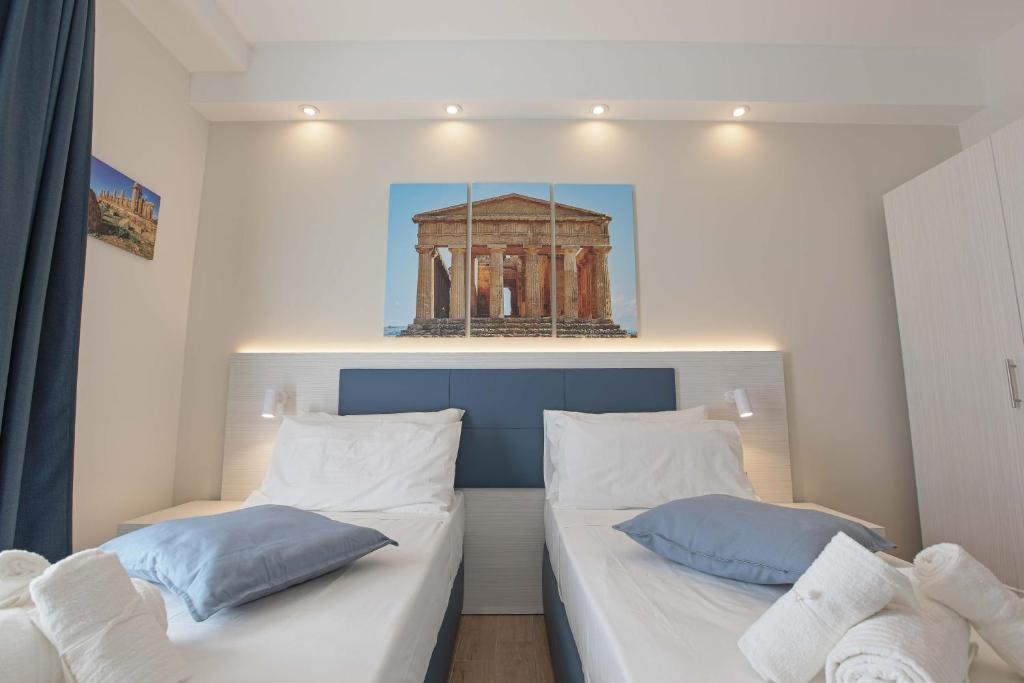 Postel nebo postele na pokoji v ubytování Esseneto Rooms