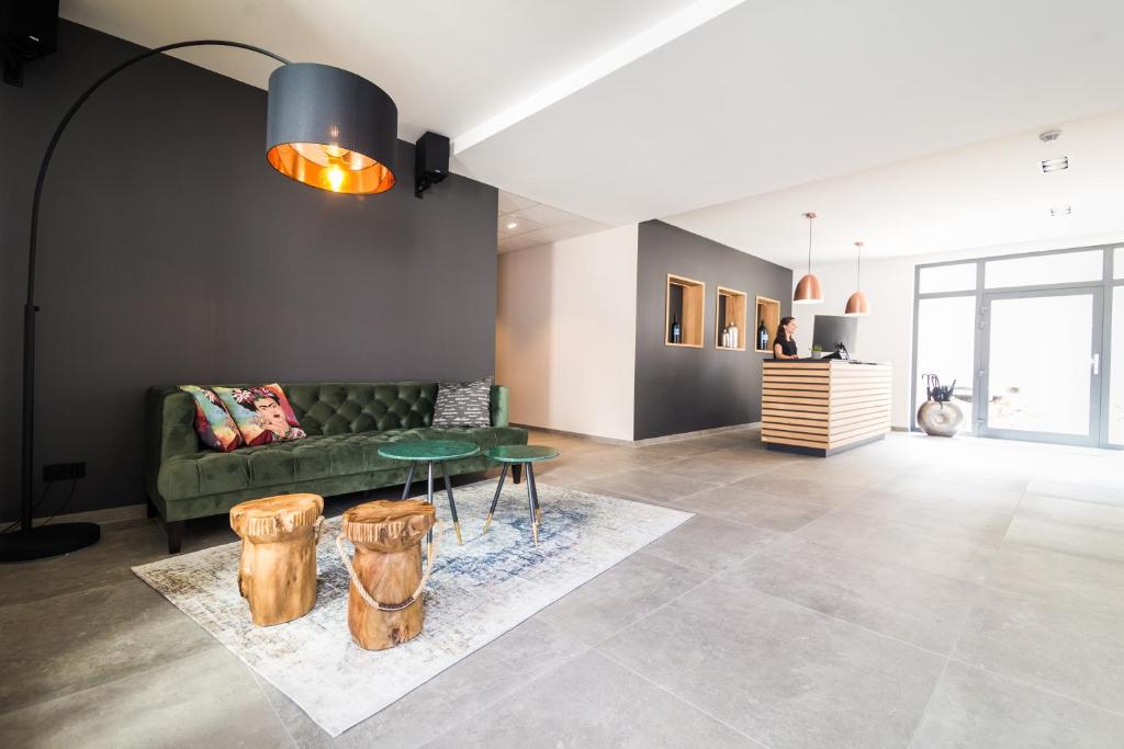 a living room with a green couch and a table at WeinQuartier Bissersheim in Bissersheim