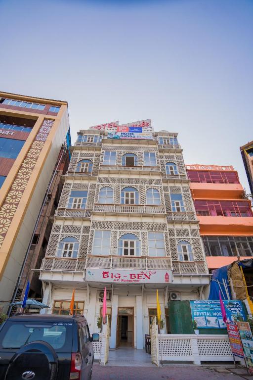 a large building in the middle of a street at Ganga Heritage - By The Palm Bliss Resort in Haridwār