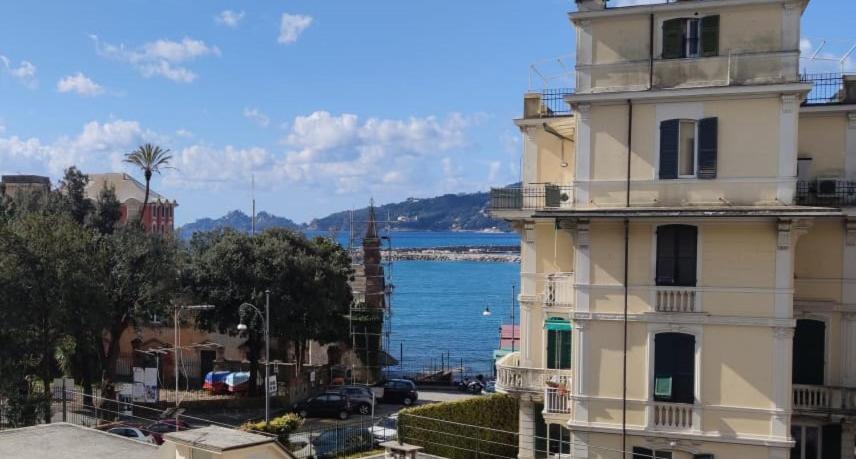 a building in front of the water with acean at Casa Tigullio in Rapallo