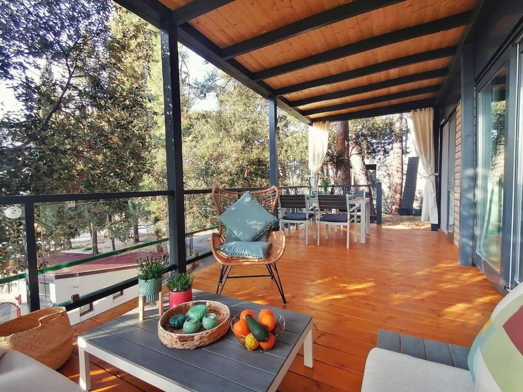 a screened in porch with a table with fruit on it at Mobile Home MORE Porton Nature Hideouts in Rovinj