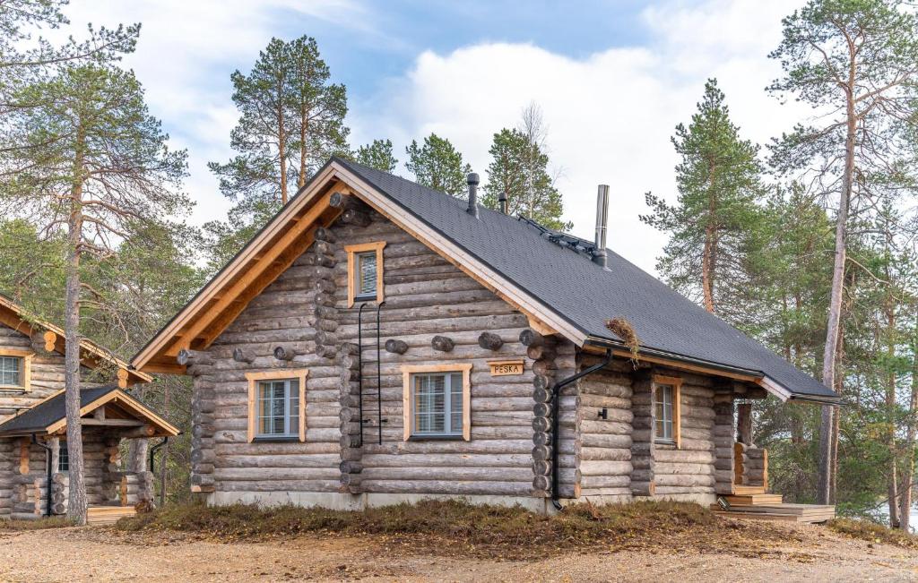 a log cabin with a black roof at Wilderness Hotel Nellim & Igloos in Inari