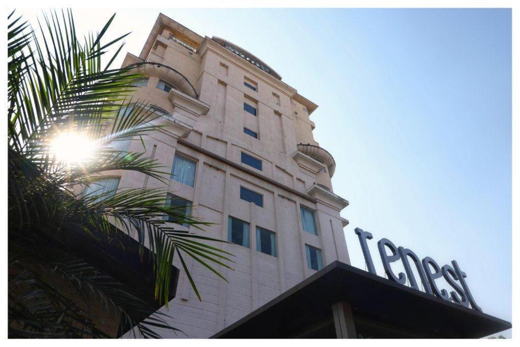 a tall building with a sign on the side of it at Renest Jaipur in Jaipur