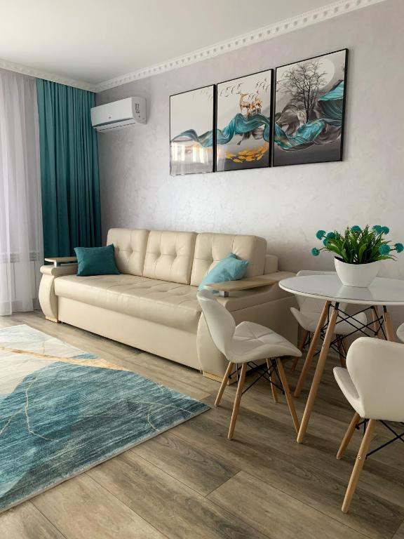 a living room with a couch and a table at Mint Apartment Солнечное Закарпатье in Polyana
