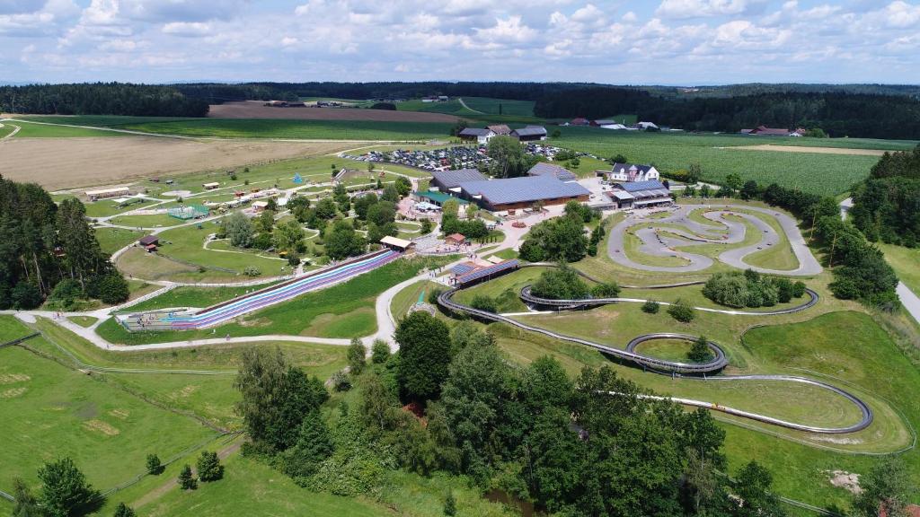 an aerial view of a park with a race track at Baumhaus Hotel Voglsam in Schönau