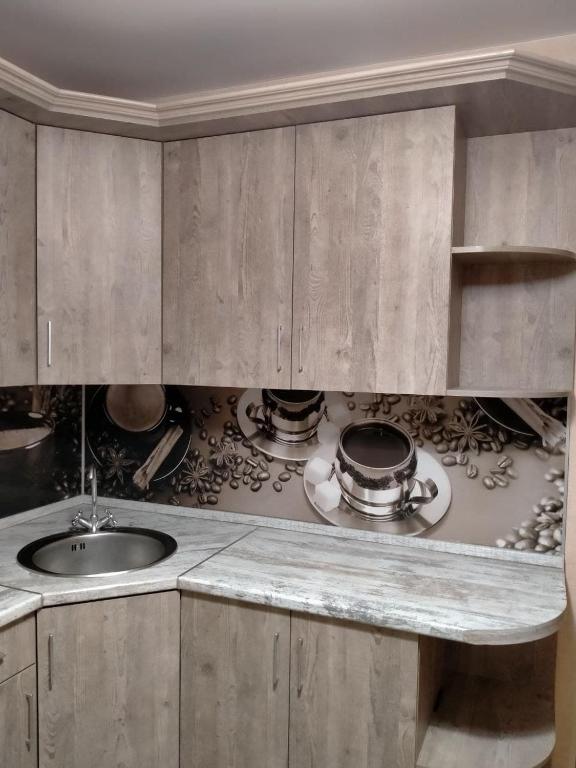 a kitchen with a sink and a counter top at Sunflower Aparts 36 in Voronezh