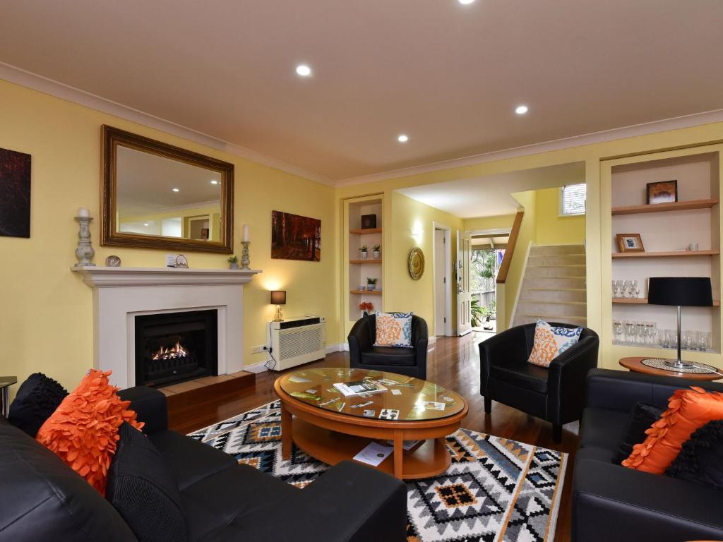 a living room filled with furniture and a fireplace at Villa 3br Penivity Villa located within Cypress Lakes Resort in Pokolbin