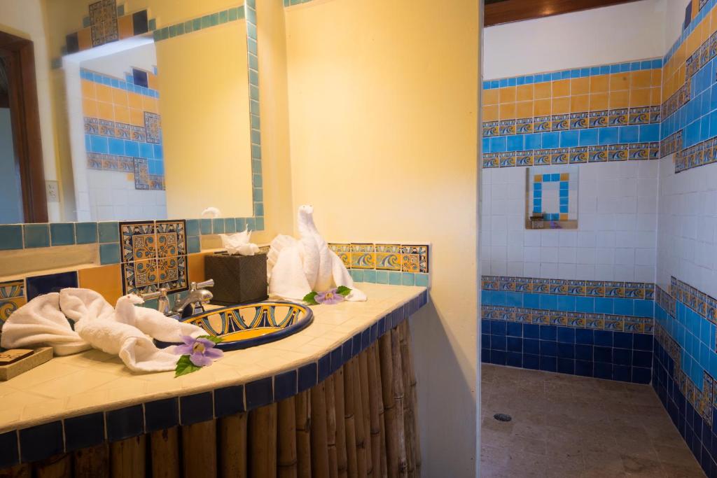 a bathroom with a sink and a mirror at Gaia Riverlodge in San Ignacio