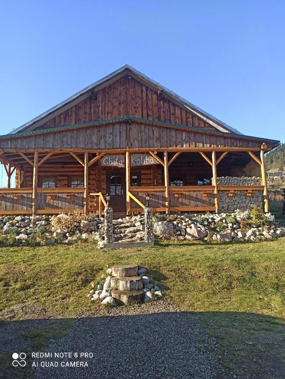 a large wooden building with a large at Chata Koliba in Stará Ľubovňa