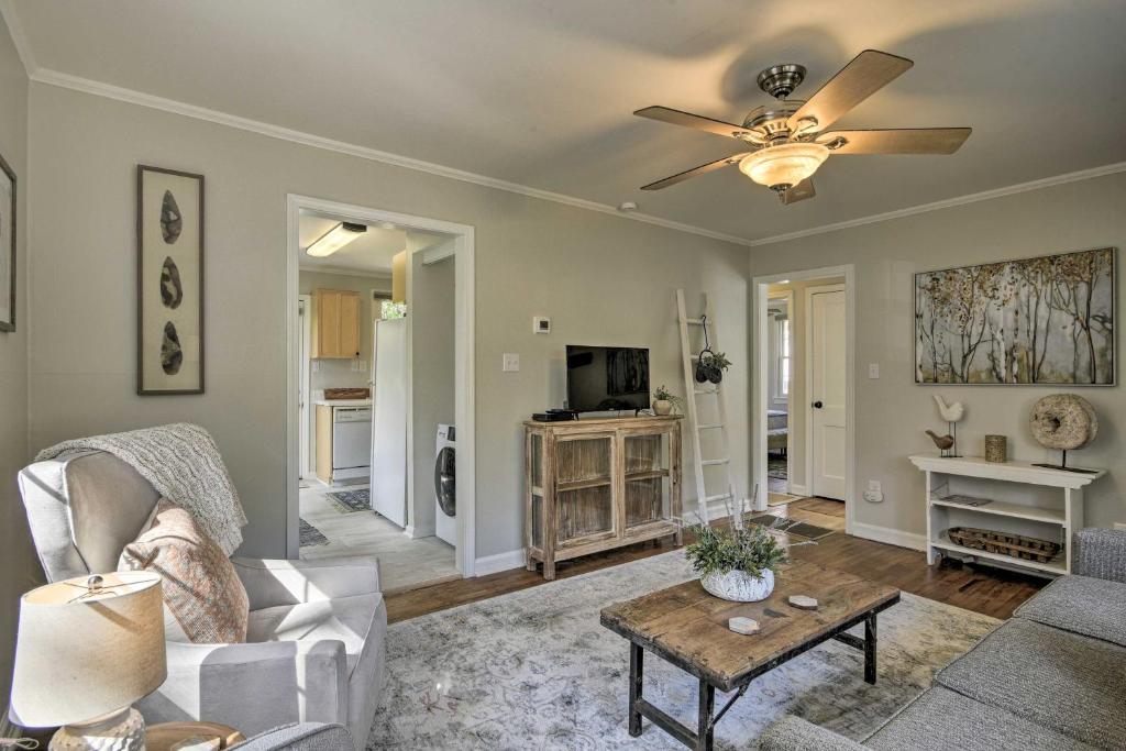 a living room with a couch and a ceiling fan at Raleigh ITB Home - Mins to Downtown and North Hills! in Raleigh