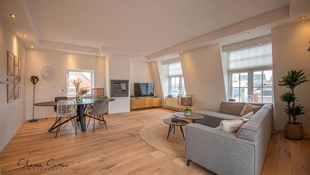 a living room filled with furniture and a fireplace at Penthouse Apartment "Trendy" Alkmaar by Urban Home Stay in Alkmaar